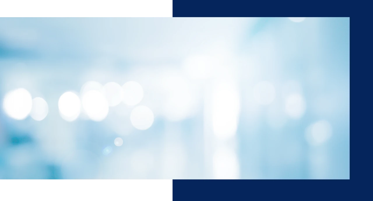Abstract image with blurry white circles on a light blue background.