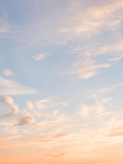 Pastel sunset sky with wispy clouds