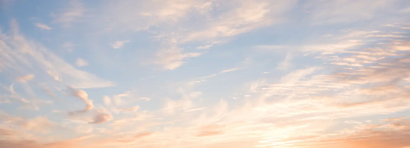 Pastel sunset sky with wispy clouds