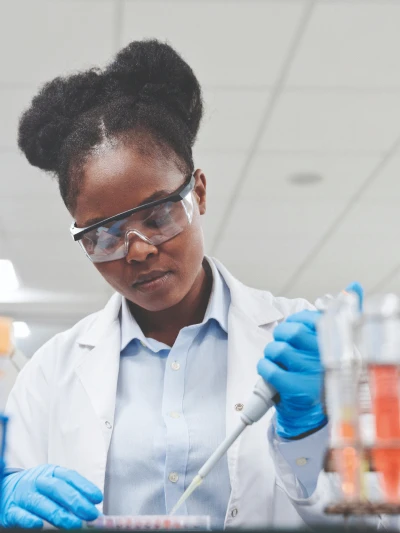 Scientist using pipette in laboratory