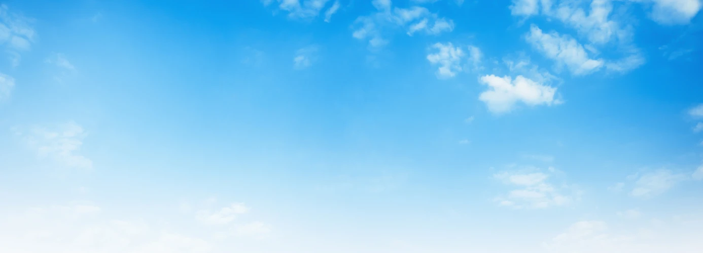 Blue sky with scattered white clouds.