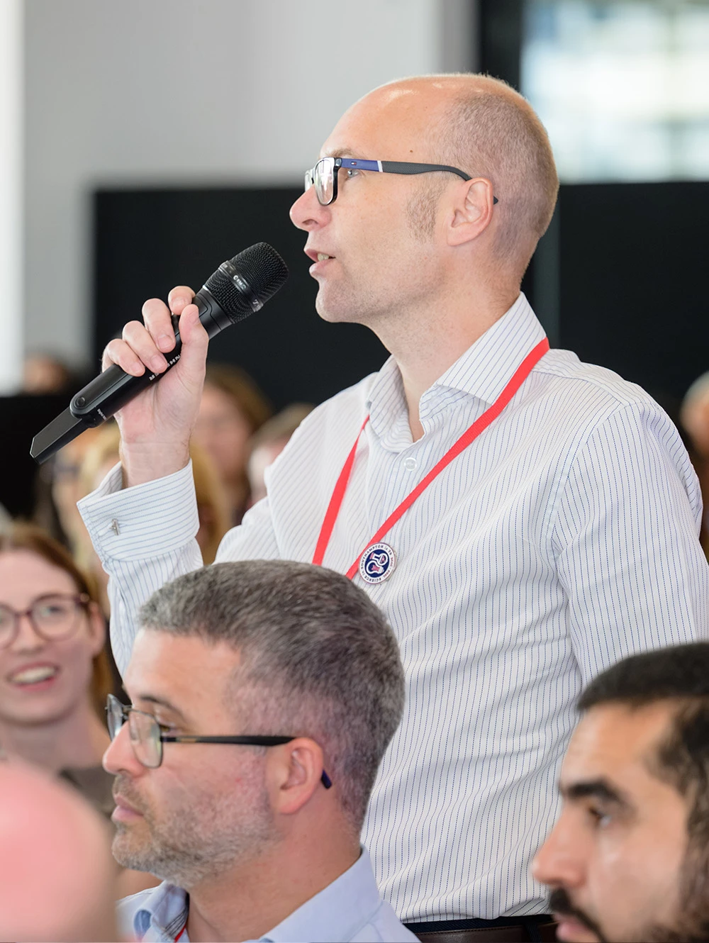 Corporate presentation with speakers on stage and large audience